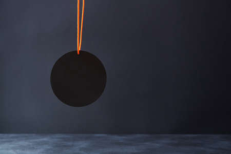 Dark background with empty round tag, copy space. Black friday. Night sale. Best offer. Total sale....