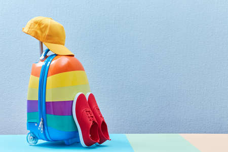 Colourful suitcase, shoes and female straw hat, place for text. Time to travel. Summer vacation. Travelling abroad.の写真素材