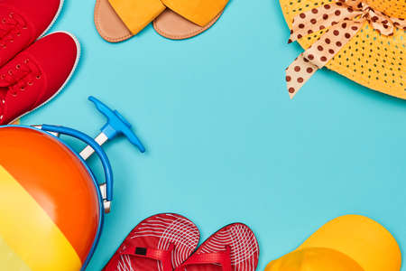 Family trip. Summer time. Travelling background. Summer vacation. Top view of suitcase, shoes and...