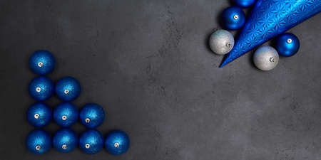 Blue and silver balls isolated on grey background. Festive cap. Happy new year and xmas concept. Copy space for textの写真素材