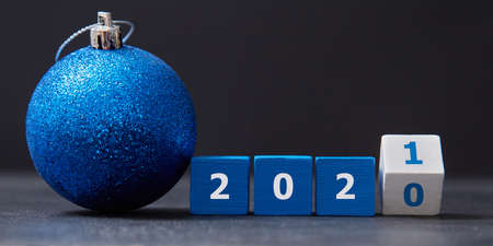 Wooden cubes with number, ball with tinsel. New year and xmas celebration. Winter holiday. Xmas decorations. Copy spaceの写真素材