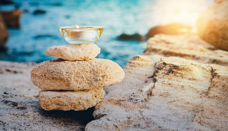 Spa composition. Unbranded white containers for cream, lotion on stones, copy space. Spa and wellness. Beauty treatment.の写真素材