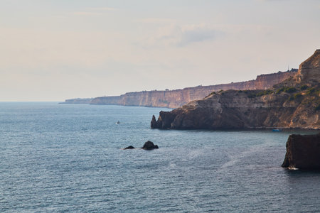 Calming ocean water. Nude beach. Seascape panorama. Virgin nature. Summer vacation. Freedom and relaxation. Sharp cliff.の写真素材