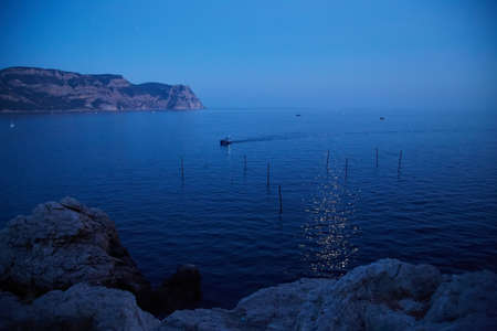Calm sea with tiny waves. Virgin nature. Sunset scenery. Summer time. Glowing wate of Golden hour.