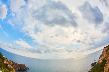 Nature landscape. Panoramic ocean view. Summer time. Fisheye effect. Blue cloudy sky. Calming sea....