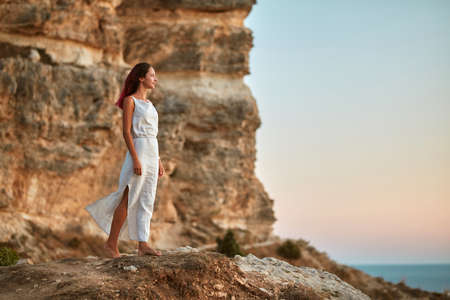 Carefree woman in dress posing on nature. Blue sky and fresh air. Contemplation time and self...