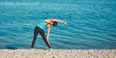 Lady leans right wearing comfy sportswear. Cute view and fresh air. Healthy lifestyle and sport...