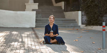 New place, street style and new emotion concept, copy space. Cute laughing woman drinking beverage...