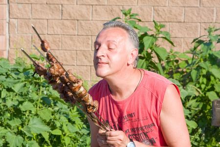 Man has control over a shish kebabの写真素材