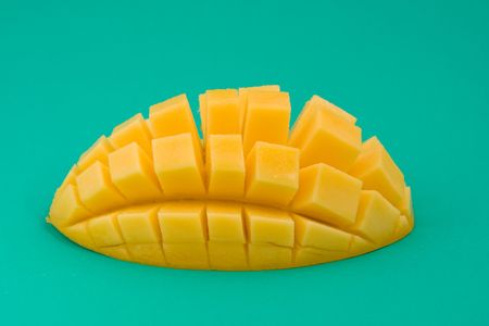 Ripe mango on a green backgroundの写真素材