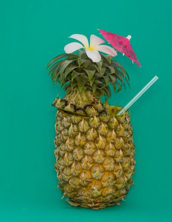 Cocktail in pineapple isolated on green backgroundの写真素材