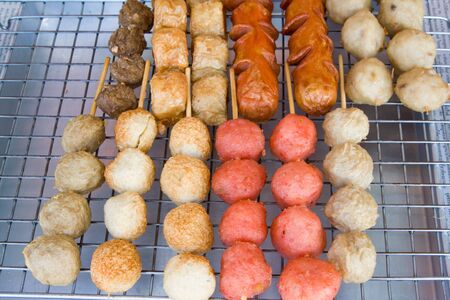 Meatballs on sticks at a market in Thailand の写真素材