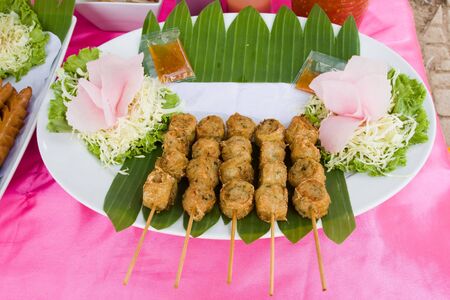 Meatballs on sticks at a market in Thailand の写真素材
