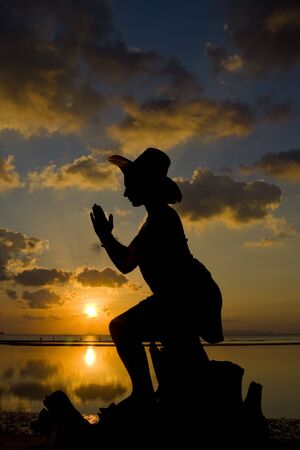 Woman silhouette in the sunset. の写真素材