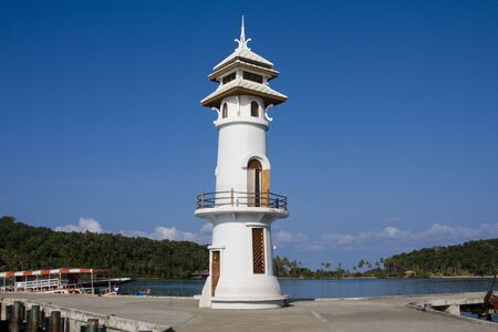 White lighthouse in bay on Koh Chang island, Thailand . の写真素材