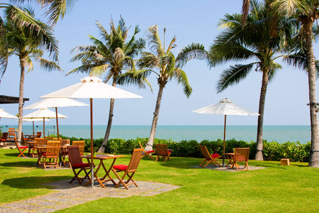 Terrace of a restaurant with white sun shades on a beautiful beachのeditorial素材