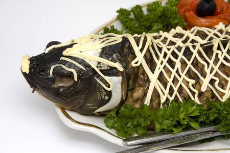 Fish carp stuffed on oval plate backgroundの写真素材