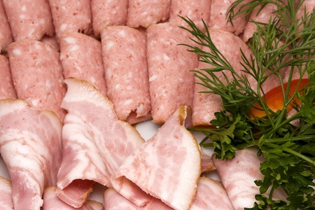 Meat assortment of beef, sausage and ham with greens