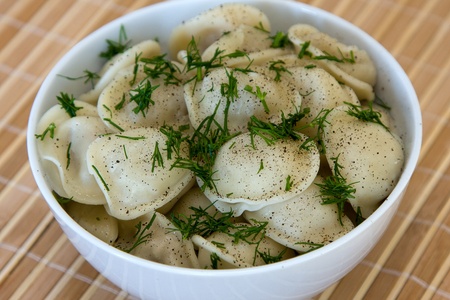 Bowl with traditional russian dish - pelmeni.の写真素材