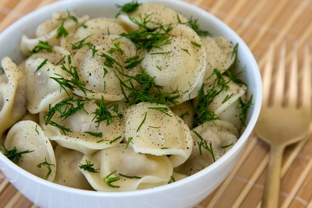 Bowl with traditional russian dish - pelmeni.の写真素材