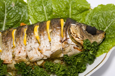 Fish carp stuffed on oval plate backgroundの写真素材