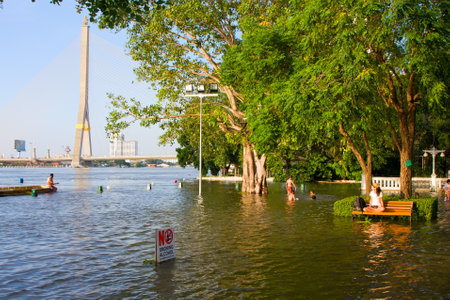 BANGKOK THAILAND - OCTOBER 26 : Flooding in Bangkok city on October 26, 2011 in Bangkok, Thailand. Water burst its banks on the Chao Phraya River to 2.5 m near the bridge Rama VIII.のeditorial素材