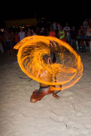PHANGAN - JANUARY 08 : There are about 10,000 people every month at this Phangan beach Full moon party, on January 08, 2012 in Koh Phangan , Thailand . Fire dancer on a beach - blurのeditorial素材