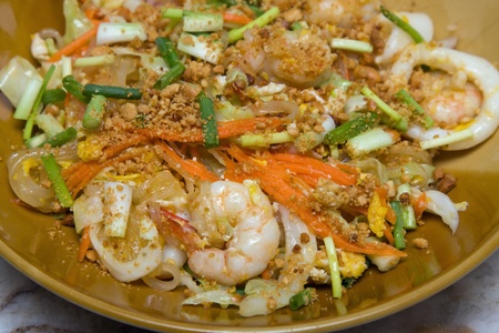 Pad thai with seafood. Thai noodle with seafood on white plateの写真素材