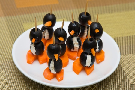 Canapes in the form of a penguin from olives, carrots and cottage cheeseの写真素材