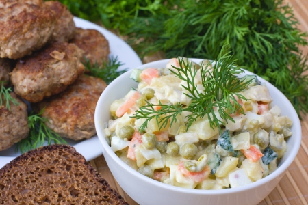 Russian traditional salad olivier in white plateの写真素材