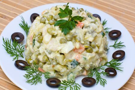 Russian traditional salad olivier in white plateの写真素材