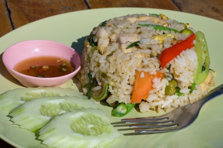 Rice with chicken and vegetables on the plateの写真素材