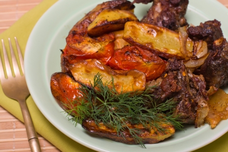 Fried meat with vegetables served on a plateの写真素材