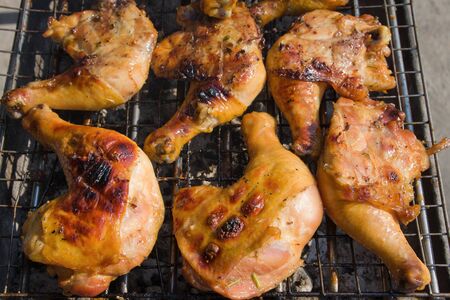 Grilled chicken legs are cooked in the restaurantの写真素材