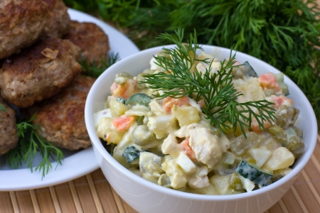 Russian traditional salad olivier in white plateの写真素材