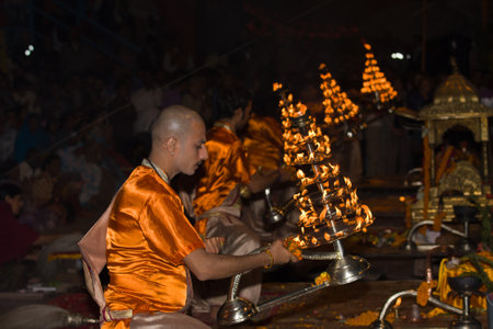 VARANASI, INDIA - DECEMBER 1: An unidentified Hindu priest performs religious Ganga Aarti ritual...