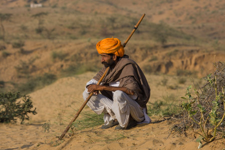 PUSHKAR, INDIA - NOVEMBER 23: An unidentified man attends the Pushkar Camel Mela on November 23, 2012 in Pushkar, Rajasthan, India. This fair is the largest camel trading fair in the world.のeditorial素材