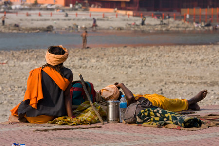 HARIDWAR, INDIA - NOV 8: An unidentified homeless people are on the sidewalk near the River Ganges on November 8, 2012 in Haridwar, India. Poor Indians flock to Haridwar for charity.のeditorial素材