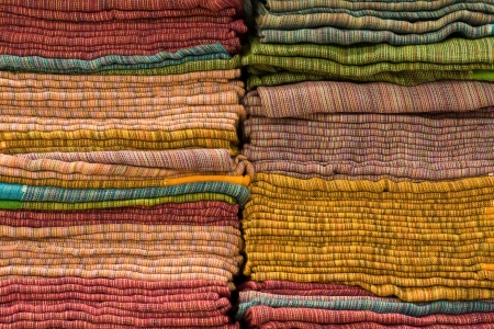 Heap of cloth fabrics at a local market in India. Close up .