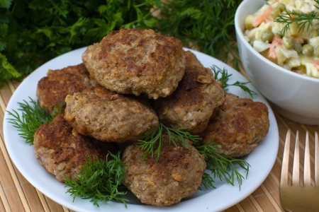 Fried cutlet with dill on a plateの写真素材