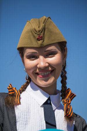 UKRAINE, KIEV - MAY 9: Ceremonial parade at Kiev main street - Khreschatyk - dedicated to the 68th Anniversary of victory in Great Patriotic War (World War II). Parade of victory on May 9, 2013 in Kiev, Ukraine. Unidentified ukrainian girl takes part in tのeditorial素材