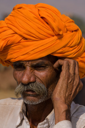 PUSHKAR, INDIA - NOVEMBER 19: An unidentified man attends the Pushkar Camel Mela on November 19, 2012 in Pushkar, Rajasthan, India. This fair is the largest camel trading fair in the world.のeditorial素材