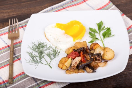 Fried vegetables and fried eggs in the shape of heartの写真素材