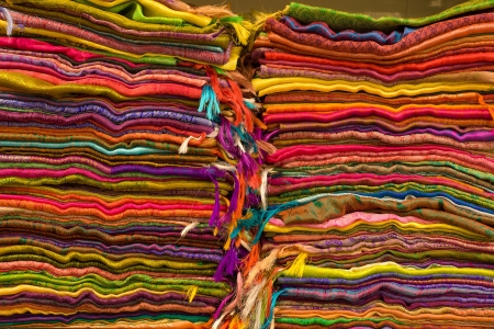 Heap of cloth fabrics at a local market in India. Close up .の写真素材