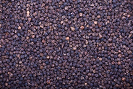 Black pepper as whole backgroundの写真素材