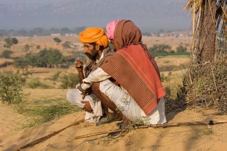 PUSHKAR, INDIA - NOVEMBER 23: An unidentified two men attends the Pushkar Camel Mela on November 23, 2012 in Pushkar, Rajasthan, India. This fair is the largest camel trading fair in the world.のeditorial素材