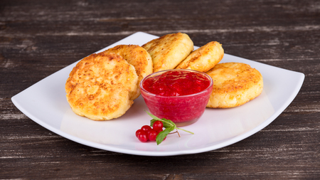 Cheese pancakes with berry jam in white plateの写真素材