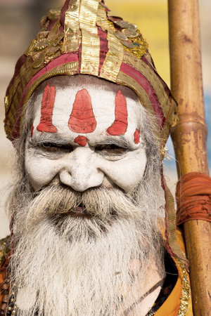 VARANASI, INDIA - NOVEMBER 30: An unidentified Hindu holy man seeks alms in front of a ghat along the river Ganges on November 30, 2012 at Varanasi, Uttar Pradesh, India.のeditorial素材