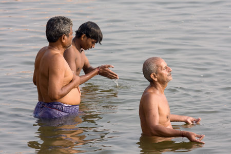 VARANASI, INDIA - DECEMBER 1: Unidentified people wash themselves in the river Ganga on December 1, 2012 in the holy city of Varanasi, India. The holy ritual is held every day.のeditorial素材