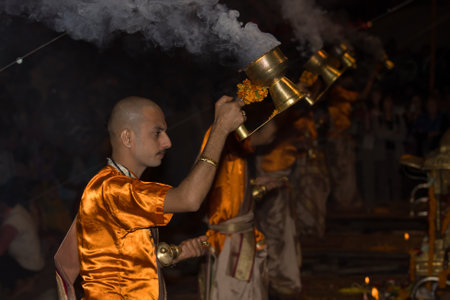 VARANASI, INDIA - DECEMBER 1: An unidentified Hindu priest performs religious Ganga Aarti ritual (fire puja) at Dashashwamedh Ghat on December 1, 2012 in Varanasi, Uttar Pradesh, Central Indiaのeditorial素材